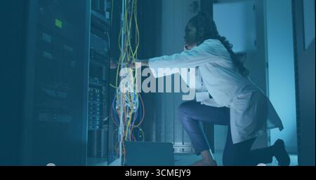 Connecting cables network tech using headset in server room with toolbox, copy space Stock Photo