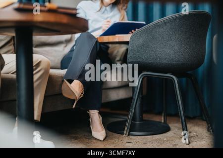 Two business associates collaborating in a modern casual office setting Stock Photo