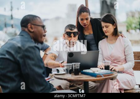 Group of professionals collaborating outdoors in a multiracial business meeting Stock Photo
