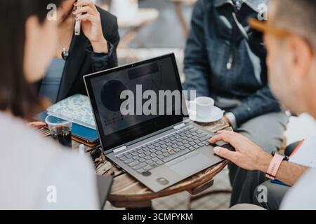 Group discussing data analytics during an outdoor business meeting Stock Photo