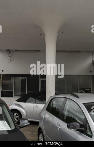 View over cars for sale on a pillar of a roof of an old petrol station or car repair shop on which surveillance cameras are mounted, Wietzen, Nienburg Stock Photo