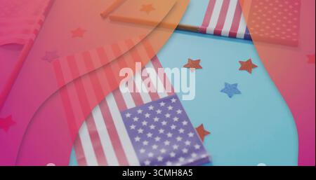 Displaying American flag picks and red-blue star-shaped glitter confetti on tabletop, patriotic Stock Photo