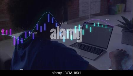 African American woman analyzing real-time data charts on laptop at brick wall desk, with succulent Stock Photo