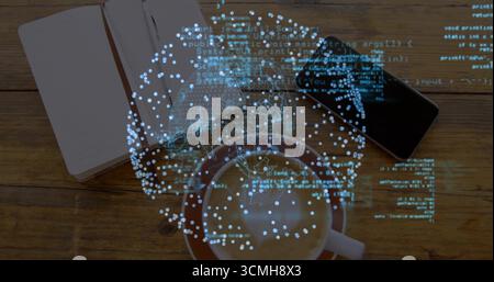 Displaying holographic globe spinning above frothy coffee cup on table with notebook and smartphone Stock Photo