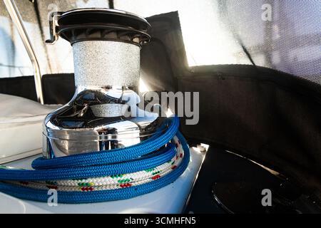 Winch mechanism for tightening the ropes on a sailing yacht with ropes. Stock Photo