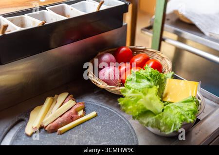 Ingredients for a Gourmet Cheeseburger: Beef, Cheese, tomato, onion, Lettuce, and spices. Stock Photo