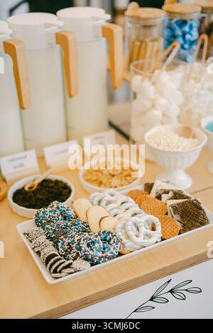 Colorful sweets like cookies and candies are showcased at a festive event, inviting guests to indulge. Stock Photo