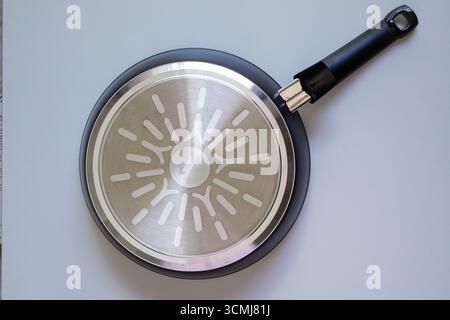 The bottom of the frying pan on white background Stock Photo