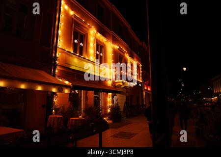 Warsaw restaurant illuminated at night with bold neon and vibrant urban curb appeal Stock Photo