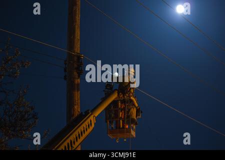 Photo of Elevated Electrical Worker Working on Electric Cables Stock Photo