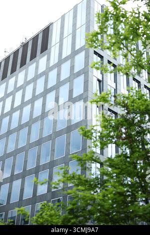 Modern glass office building facade with reflective windows detail Warsaw, Poland Stock Photo