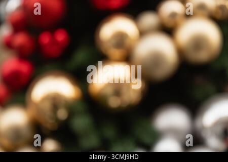 Blurred Christmas background with red and golden balls. Abstract pattern. Xmas holiday spirit. Stock Photo