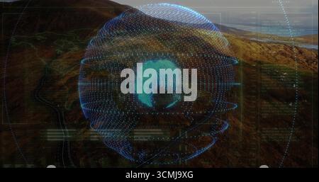 Projecting holographic globe spinning over rocky valley, with UI panels, rings, map lines and code Stock Photo
