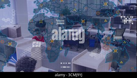 Collaborating team analyzing data at open?plan office, with dual monitors, world map overlay Stock Photo