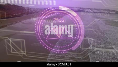 Displaying circular HUD overlay over sandy beach and rocky cliffs, with numeric gauge and overlays Stock Photo