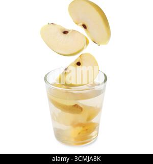 Compot ingredients. Fresh apple pieces falling into glass of drink ...