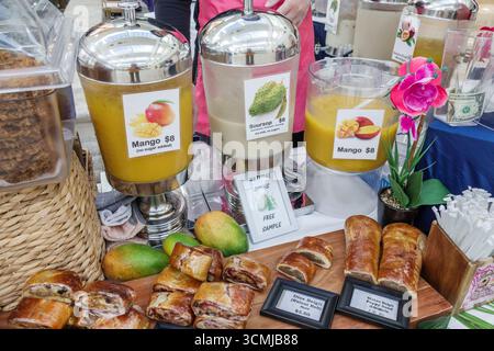 Aventura Mall Miami Florida,inside interior shopping,natural juice vendor stand closeup,mango soursop passion fruit drinks no sugar added,glass dispen Stock Photo
