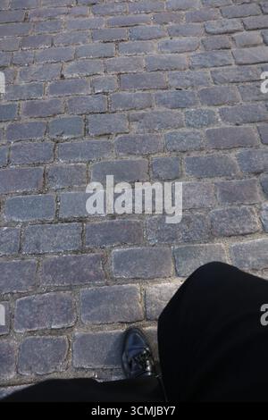 Warsaw cobblestone street with black shoe, textured patterns and creative urban minimalism Stock Photo