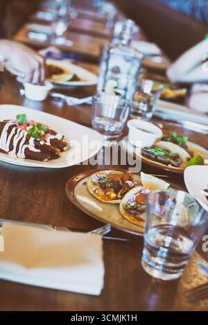 Close-up of Mexican tacos with vegetables on a table in a restaurant Stock Photo