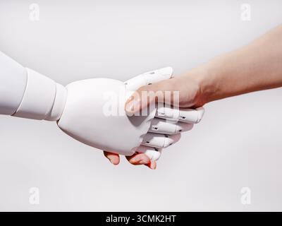 Human hand shakes robot's hand Stock Photo