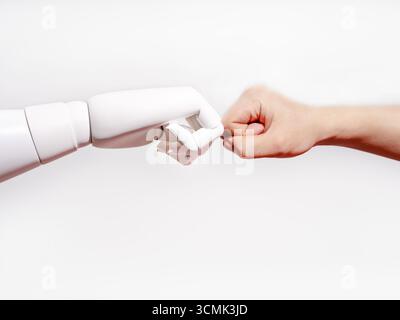 Human hand and robotic hand fist bump Stock Photo