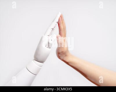 Human and robot hands touching Stock Photo