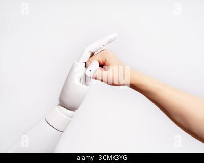 Human and robot fingertips touching Stock Photo