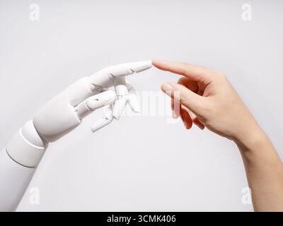 Human and robot fingertips touching Stock Photo