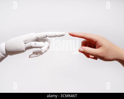 Human and robot fingertips touching Stock Photo