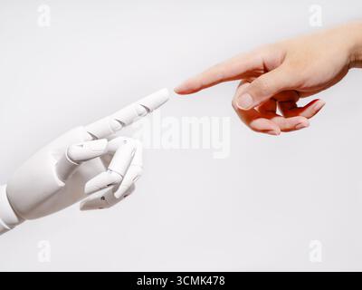 Human and robot fingertips touching Stock Photo