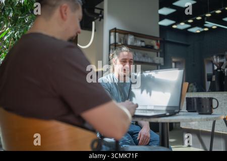 Two knowledgeable professionals collaborating effectively together in a modern workspace setting Stock Photo