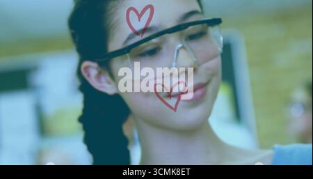 Teenage student testing circuit in school lab, wearing clear safety goggles with red heart symbols Stock Photo