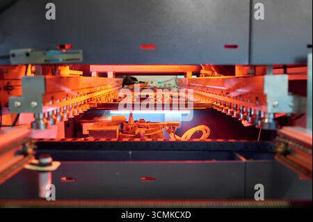 Surface mounting process of printed circuit boards in reflow soldering stage at an electronics manufacturing facility Stock Photo