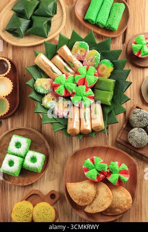 Top View Various Colorful Jajan Pasar, Traditional Indonesian Snack on Wooden Table Stock Photo