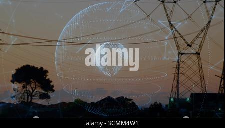 Projecting holographic globe rotating over suburban power corridor, with tower and network rings Stock Photo