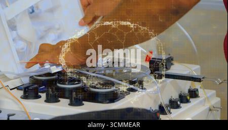 Technician hands in red shirt adjusting tubing in med lab with apheresis machine and data overlay Stock Photo