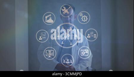 Operating scientist wearing lab coat in hall, displaying tools network data icons on digital panel Stock Photo
