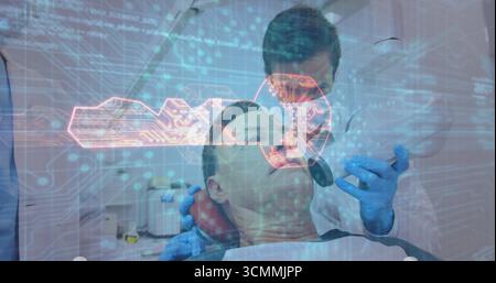 Examining dentist leaning over patient in dental chair at clinic, with handheld instrument and lamp Stock Photo