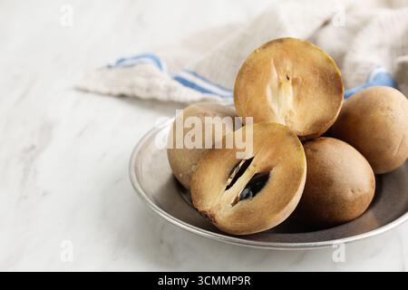 Buah Sawo or Sapodilla Fruit (Manilkara zapota). Tropical Fruit Known as Sapota, Chikoo, Chico, Naseberry, or Nispero. Stock Photo
