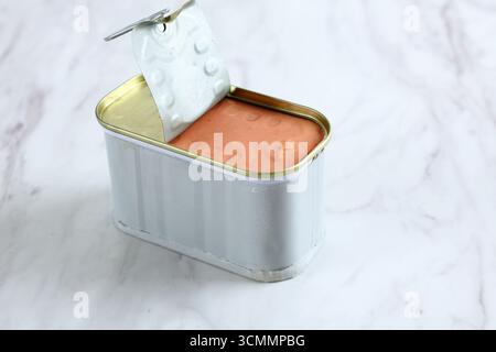 Luncheon Spam Ham Beef Corned on Tin Can, Isolated on Marble Table Stock Photo
