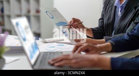 Data Visualization. Business team analyzing financial reports with charts and graphs. Stock Photo