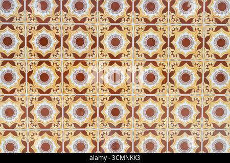 Decorative tiles featuring a repeating circular motif in warm brown, yellow, and white tones. Stock Photo