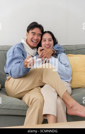 Winter happy couple enjoys home indoors, people share cozy moments during cold winter season Stock Photo