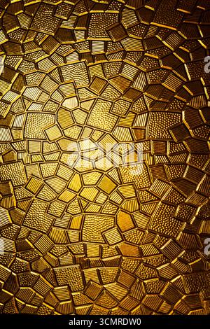 Golden antique metal plate with polygonal texture and geometric pattern, close up Stock Photo