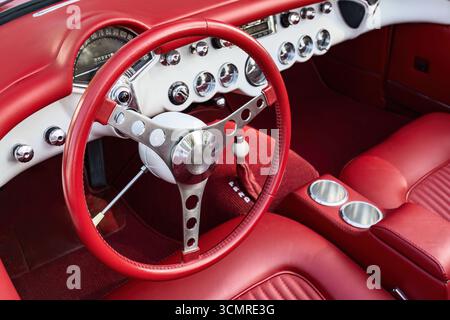 Vintage Red Sportscar Interior with Polished Dashboard and Steering Wheel Design Stock Photo
