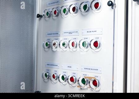 Dashboard with buttons to start and stop systems in the ship's engine room. Stock Photo