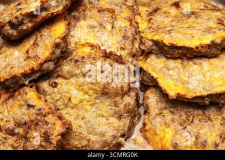 Several fried cutlets in egg batter in oil, top view. Stock Photo