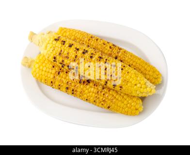 Three tasty grilled corncobs isolated on white, top view Stock Photo