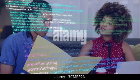 Coworkers reviewing code overlay on office grey sofa, holding yellow folder laptop red coffee cup Stock Photo