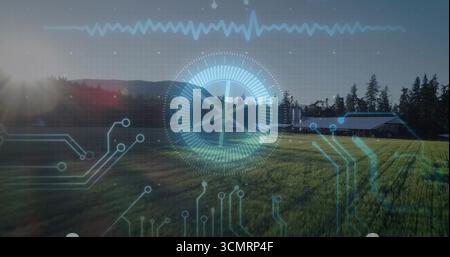 Displaying central circular gauge overlaying farmland with sun glare lens flare, with barn silos Stock Photo